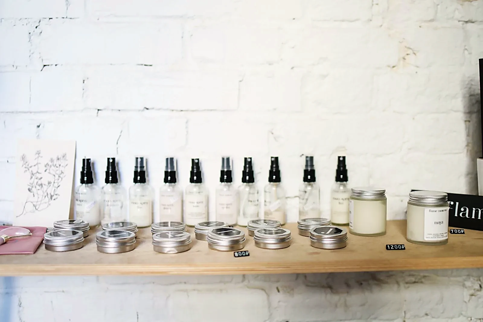 Skincare bottles and jars lined up on a wooden shelf