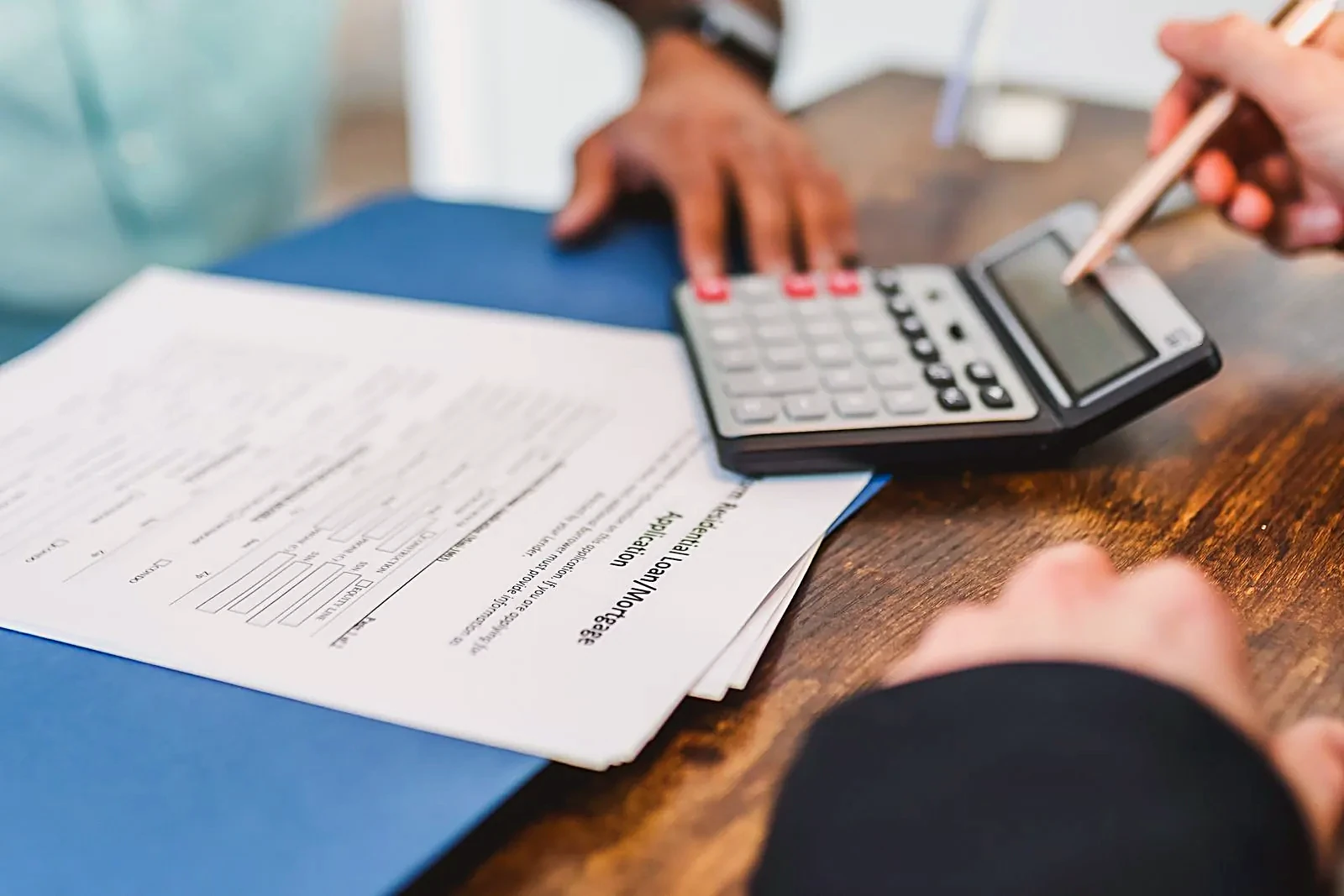 Calculator on top of mortgage and closing documents